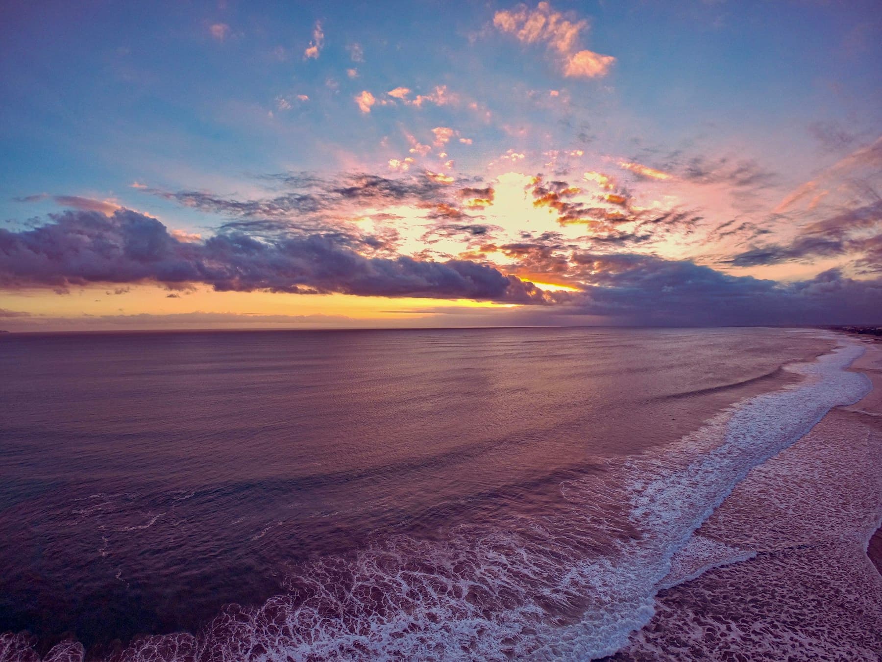 Waves along the beach at sunset in Seminyak